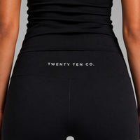 TwentyTenCollective black recycled polyester elastane flared leggings with hidden waistband pocket.
