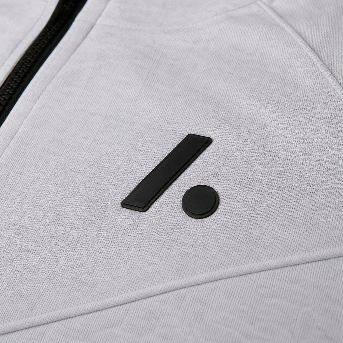 TwentyTenCollective light grey tech fleece hoodie with black logo detail and zipper.
