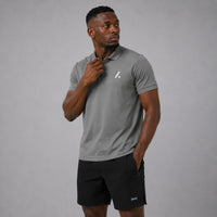 TwentyTenCollective Men's grey performance short sleeve polo shirt with white logo detail. Classic collar, button placket.